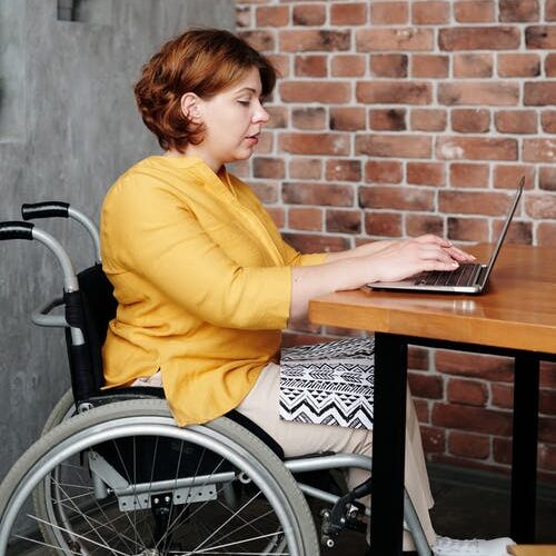 An image of an employee working on a laptop.