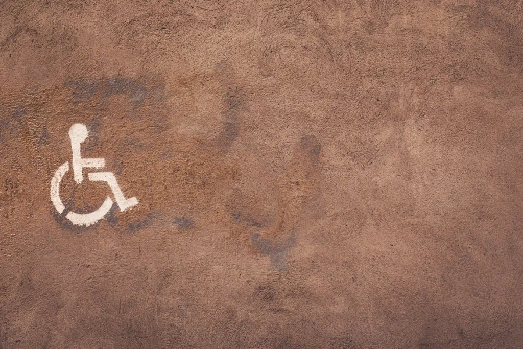 An image of a wheelchair accessibility sign painted on pavement.