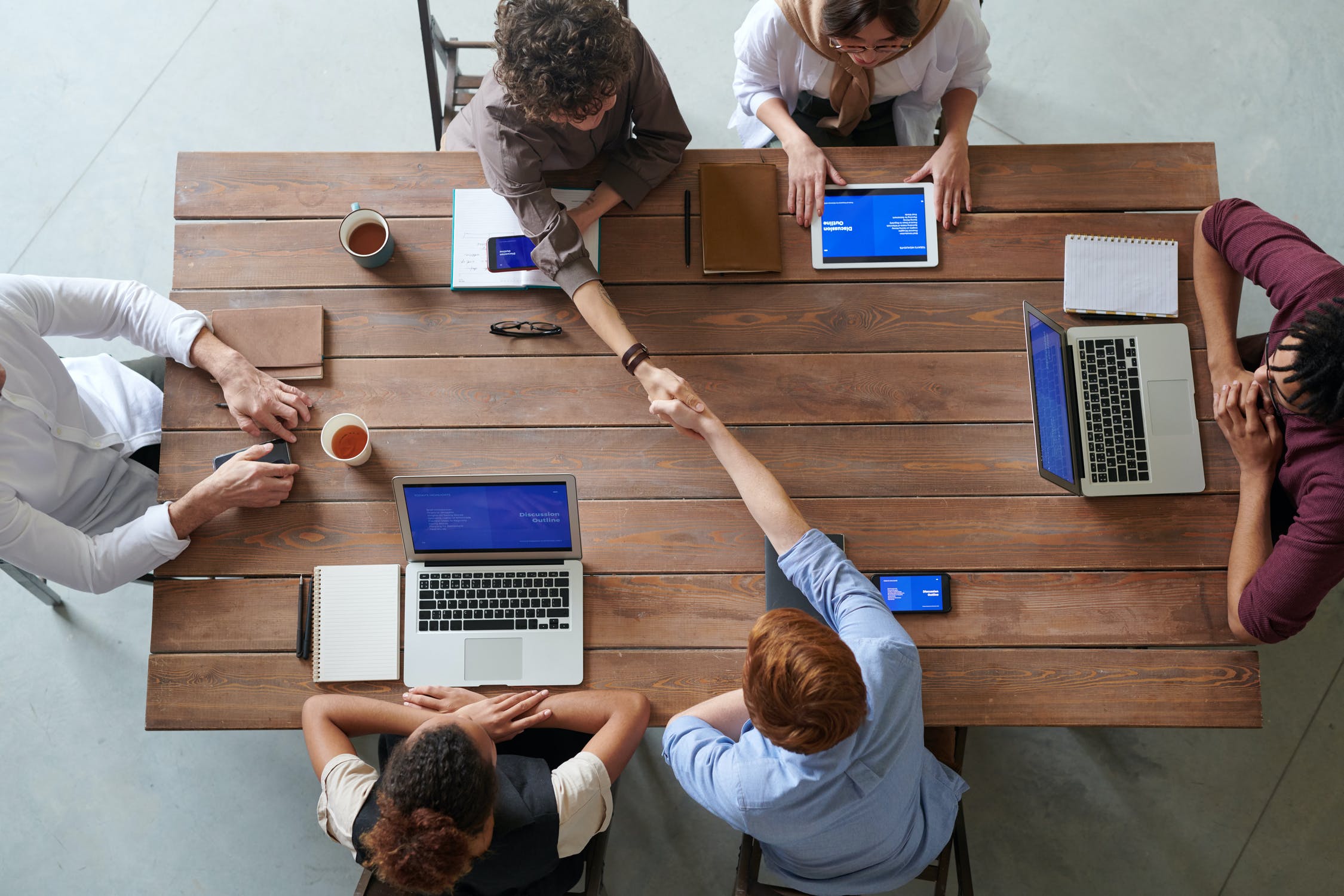 An image of six colleagues sitting around a table.