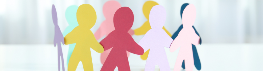 An image of paper cut-outs of people positioned in a circle and holding hands.