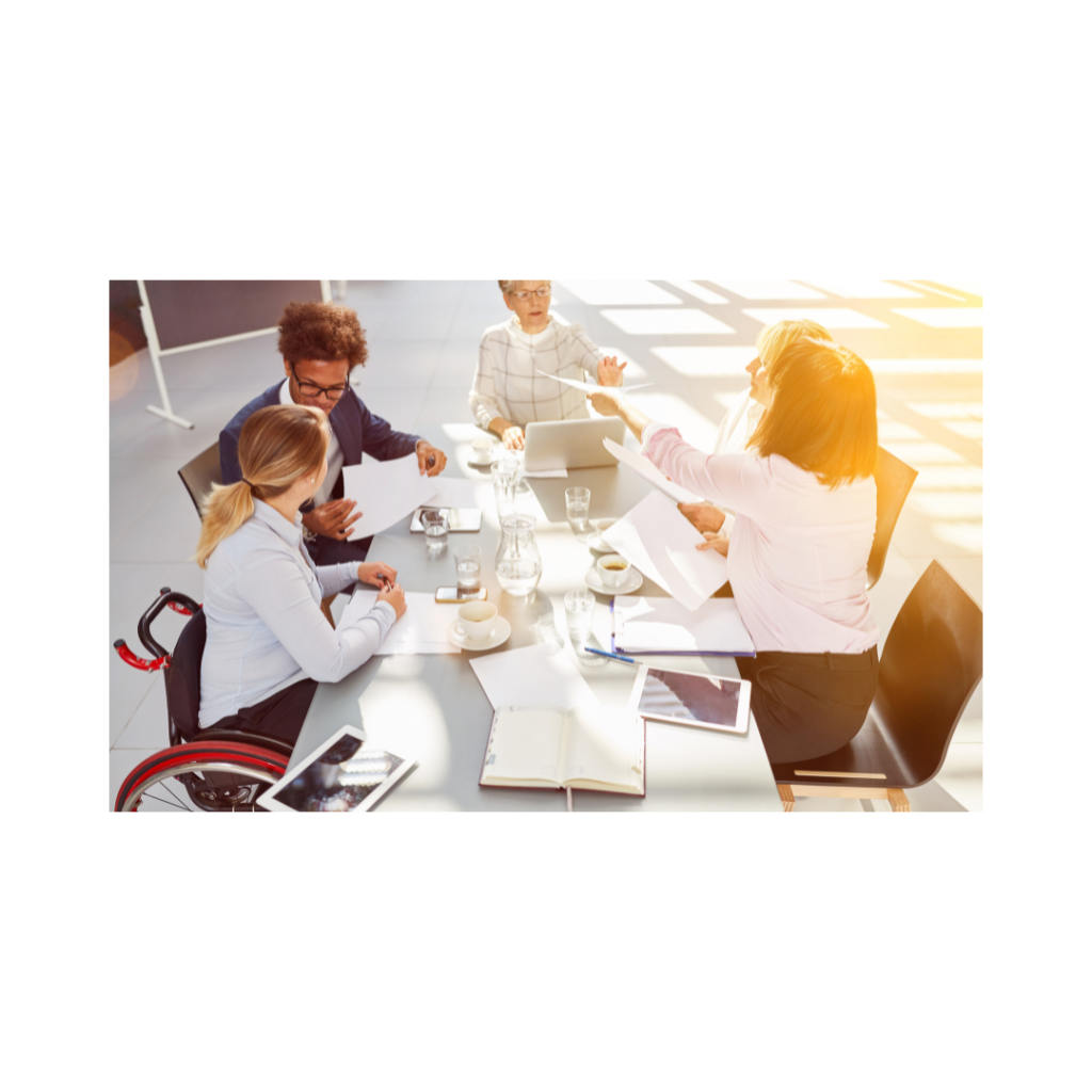 An image of five colleagues working around a table.