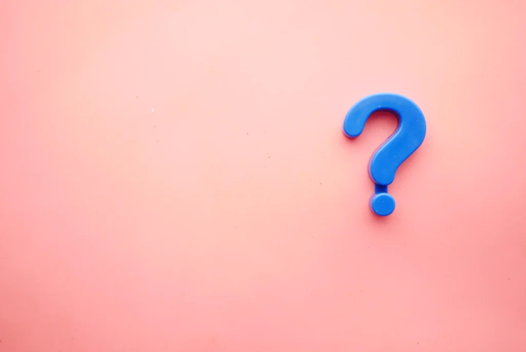 An image of a blue question mark against a pink background.